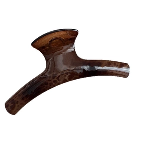 Elegant oval leopard print hair claw clip in dark brown tortoiseshell resin with a glossy finish