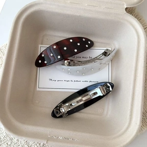 Elegant acetate hair clips in oval shapes with rhinestone embellishments in a gift box
