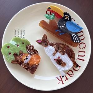 Creative forest animal hair claws featuring toucan, kangaroo and squirrel designs