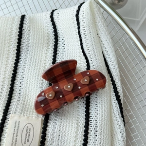 Detail of brown plaid claw clip with 3D hearts and sparkling crystal rhinestones