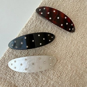 Three-piece oval acetate hair clips with rhinestones in tortoise, black, and marble white