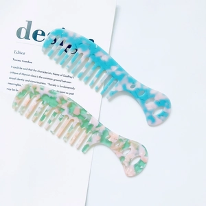 Portable wide-tooth marble acetate hair combs in pastel blue and green patterns