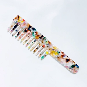 Detail of vintage marble pattern acetate comb showing wide and fine teeth design
