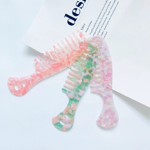Three-piece acetate hair comb set with floral marble patterns in pink, green and purple