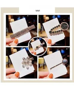 Close-up of elegant pearl and rhinestone hair clips with floral and geometric designs