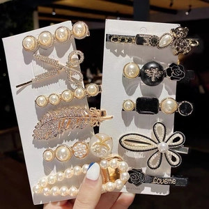 Set of 11 elegant hair clips with pearls and rhinestones on white display cards