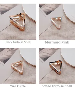 Detailed view of acetate triangle hair claws in marble and tortoiseshell patterns