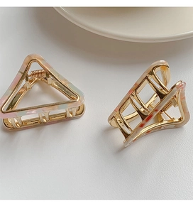 Detail view of acetate marble patterned triangular and rectangular hair claw clips set