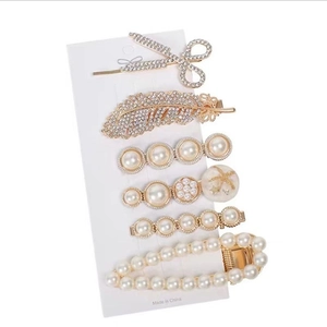 Elegant 6-piece gold hair clip set with pearls and rhinestones on display card
