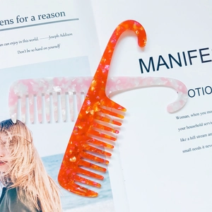 Close-up of marble pattern wide-tooth acetate combs with convenient hook handle