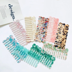 Flat lay of colorful acetate wavy hair combs with vintage tortoiseshell and floral patterns
