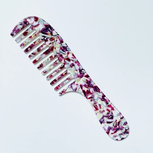 Macro shot of purple marble wide-tooth comb made of high quality acetate resin