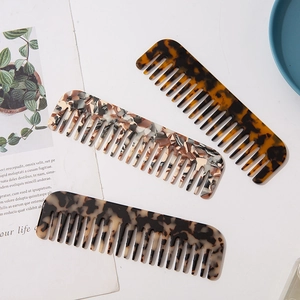 Detail of wide-tooth acetate combs in marble, tortoiseshell, and leopard print textures