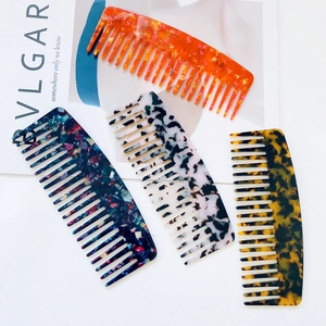 Acetate wide-tooth hair combs in various fashion patterns on a minimalist white background