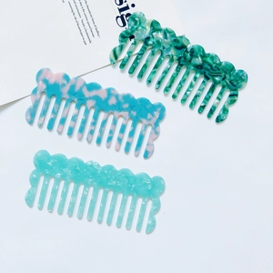Three acetate fiber hair combs featuring marble patterns and smooth wavy top design details