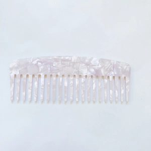Close-up of pink marble pattern on anti-static acetate wide-tooth hair comb