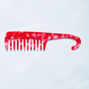 Detail of red marble acetate wide-tooth comb showing convenient hanging hook design