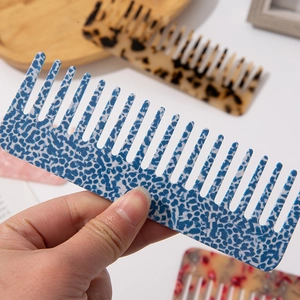 Portable wide-tooth acetate hair comb in blue marble pattern with anti-static design