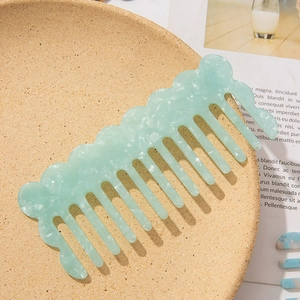 Mint green marble acetate wide-tooth comb with wavy handle for wavy hair grooming