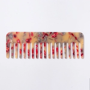 Artistic acetate wide-tooth hair comb with elegant floral marble pattern on white background
