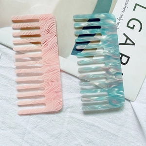 Elegant wide-tooth acetate hair combs with marble pattern in pink and turquoise shades