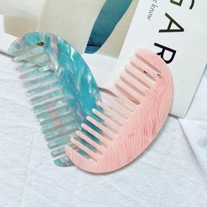 Polished acetate wide-tooth hair combs in blue marble and pink wavy textures