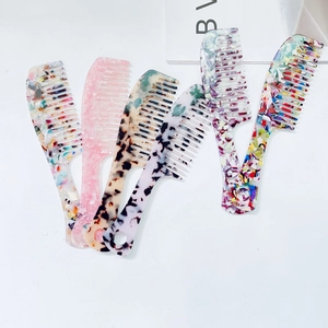 Detail view showing six acetate hair combs with various marble and tortoiseshell patterns