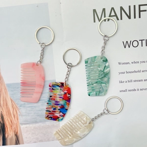 Mini acetaat haarkam sleutelhanger met marmer- en bloemmotieven en een zilveren ring