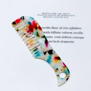 Detail of colorful marble acetate wide-tooth hair comb with convenient hanging hole