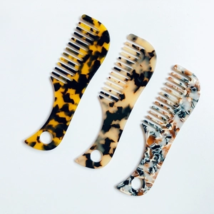 Set of three mini acetate hair combs with tortoiseshell patterns and hanging holes