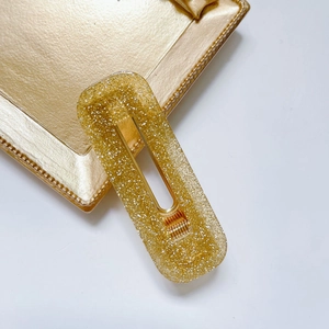 Fermaglio per capelli rettangolare in acetato glitterato dorato con molla in metallo