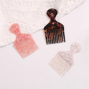 Three acetate hair combs with floral, tortoiseshell, and pearl patterns in detail