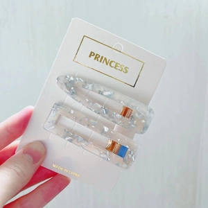 Close-up of blue marble pattern acrylic hair clips on princess display card