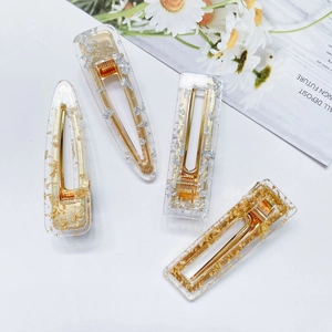 Detailed set of acrylic hair clips featuring gold and silver foil flakes in resin
