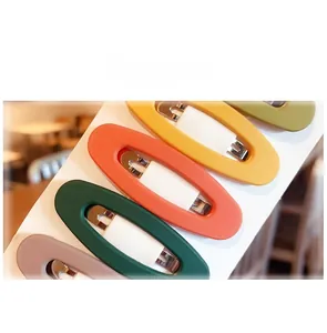 Detailed close-up of matte candy-colored hollow oval BB hair clips on display card