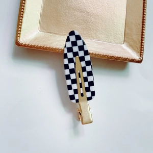 Classic black and white checkered hair clip with gold metal duckbill clamp base