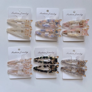 Set of 12 cute cat-shaped acetate hair clips in assorted marble and tortoiseshell patterns