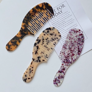 Three-piece acetate tortoiseshell wide tooth hair combs with long handles in various patterns