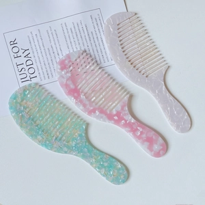 Three-piece acetate wide-tooth hair combs set in marble patterns on minimalist background