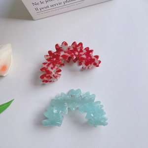 Floral print and light blue translucent hair clips displayed with elegant tulips