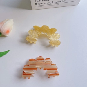 Set of two minimalist flower pattern hair claw clips in glitter gold and striped acetate