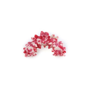 Minimalist red and white checkered acetate flower hair claw clip with a glossy finish