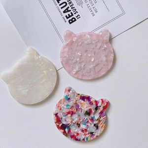 Acetate cat-shaped pocket mirror and hair accessory in elegant pearlescent finishes