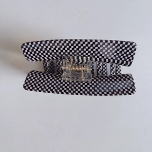 Classic black and white checkered acetate hair claw clip with golden metal spring