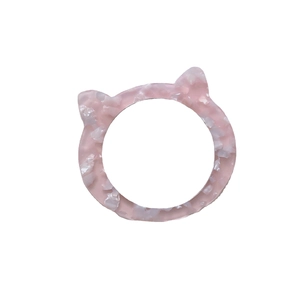 Pink marble acetate cat ear ring accessory with stylish stone texture on white background