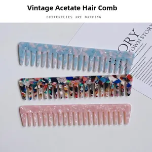 Macro detail of three retro acetate wide-tooth hair combs in various vintage marble patterns