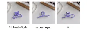 Detail view of matte lavender shark hair clips in panda and cross styles on desk