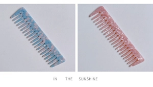 Detail view of acetate wide-tooth combs with pink and blue marble textures