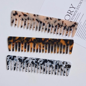 Wide tooth acetate hair combs in tortoise shell and marble patterns for styling