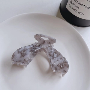 Detail of grey marble acetate claw clip with polished finish and sturdy grip teeth
